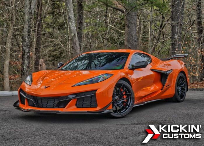 XPEL PPF Install Lotus Emira Door Panel Paint protection film being applied to the door panel of a red Lotus Emira at Kickin' Customs.