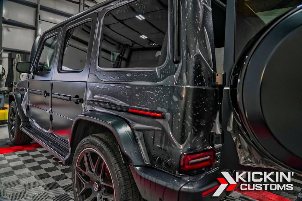 • Stealth paint protection film install in progress on a Mercedes G-Wagon at our Wrentham MA facility, blending satin finish with rugged protection.