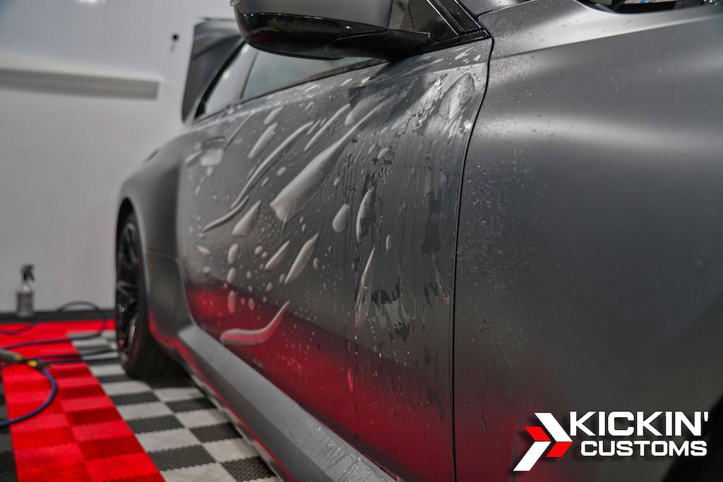 stealth-ppf-closeup-installation-kickin-customs-waltham-ma Stealth paint protection film installation close-up, applied at Kickin’ Customs for a Waltham MA client.